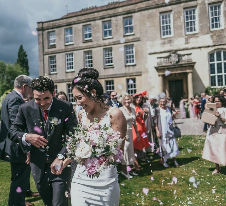 Confetti Moment with Bride in Pronovias Wedding Dress and Groom in Cad &amp; The Dandy Suit