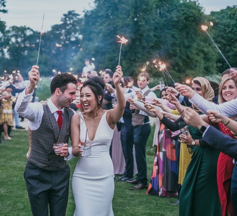 Sparkler Moment with Bride in Fitted Wedding Dress and Groom in Plaid Cad &amp; The Dandy Waistcoat