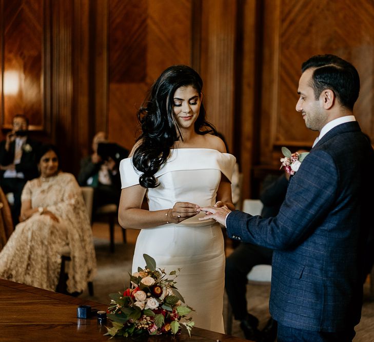 Bride and groom exchanging rings at civil ceremony