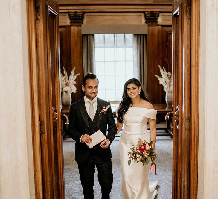 Bride and groom exit the ceremony room as husband and wife