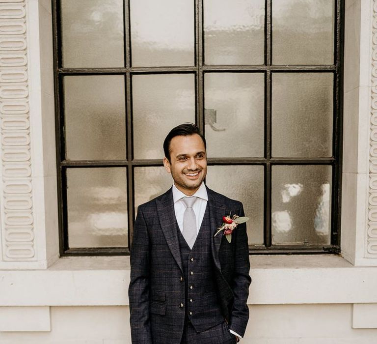 Groom in navy check wedding suit