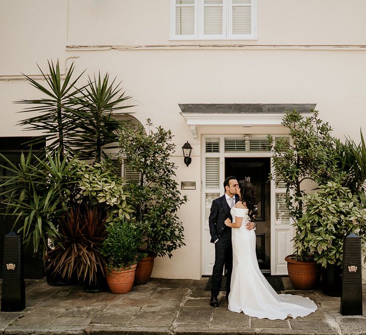 Bride and groom portrait by some plants