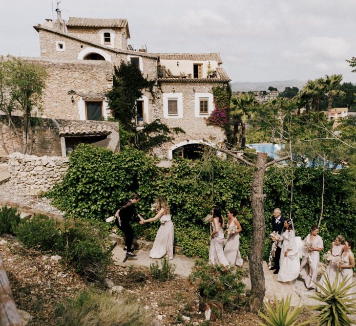 Bridal Party Walking to the Outdoor Wedding Ceremony at Almiral de la Font Barcelona Manor House  Wedding Venue