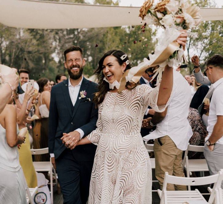 Bride in Margaux Tardits Wedding Dress  and Groom in a Navy Wedding Suit  Just Married