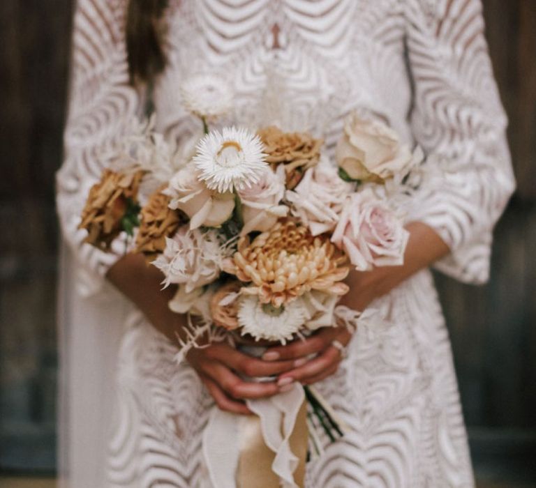 Bride in Margaux Tardits Wedding Dress Holding a Nude Rose and Dahlia Wedding Bouquet Tied with Ribbon