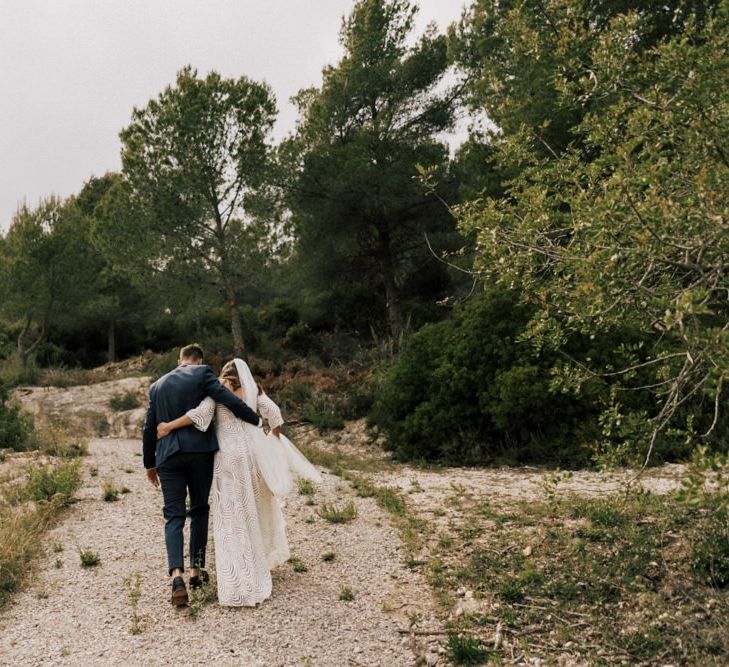 Stylish Bride and Groom Walking Down a Country Lane