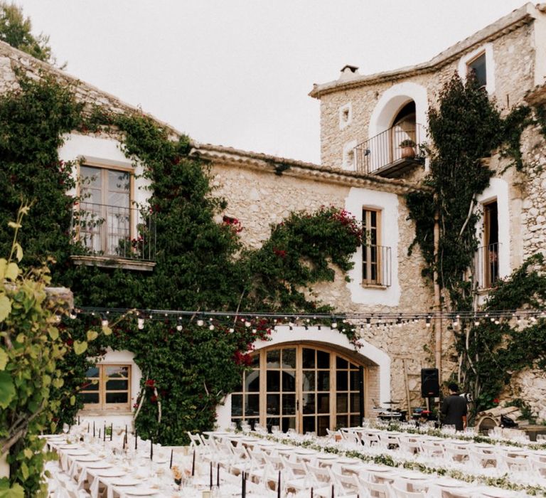 Outdoor Wedding Reception at Almiral de la Font in Barcelona with White Tables and Festoon Lights