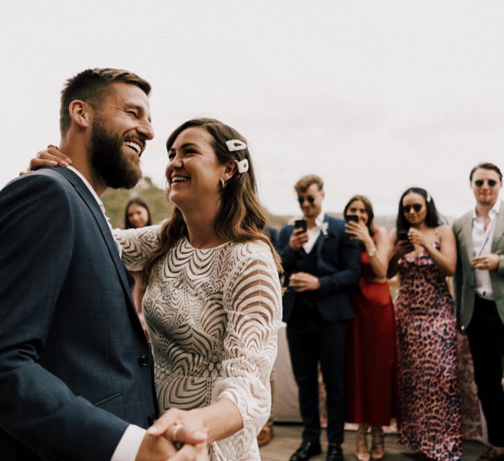 First Dance with Groom in Navy Suit and Bride in Swirl Patterned Wedding Dress