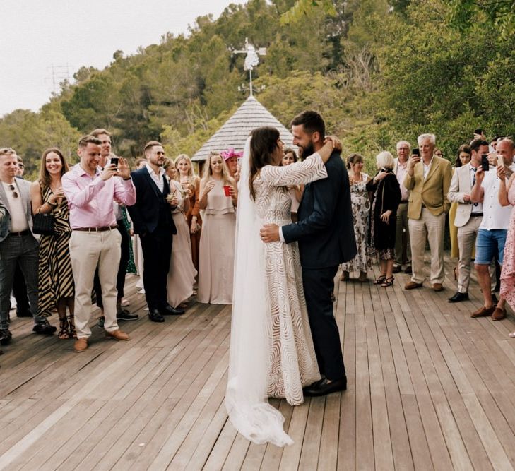 Bride in Margaux Tardits Wedding Dress and Groom in Navy Moss Bros. Suit Having Their First Dance