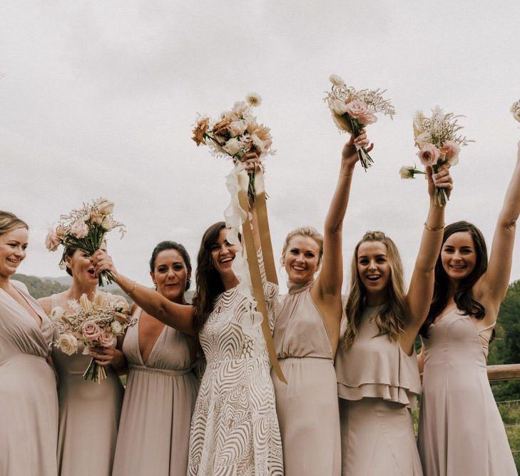 Happy Bridal Party Portrait with Bridesmaids Waving Their Bouquets