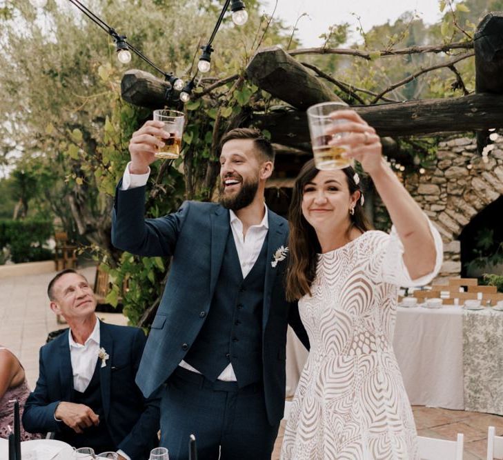 Bride and Groom Raising Their Glass at the Wedding Reception