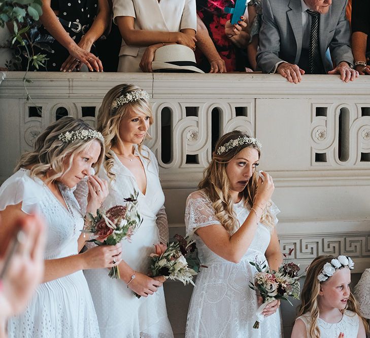 Bridesmaids in Different White Dresses and Flower Crowns Crying During the Wedding Ceremony