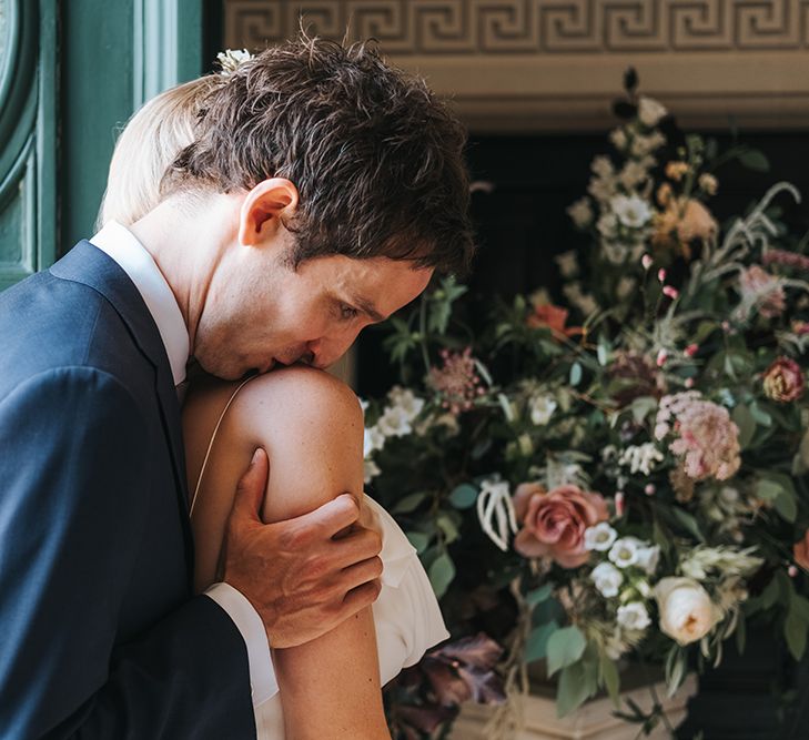 Groom Kissing His Brides Shoulder During The Wedding Ceremony