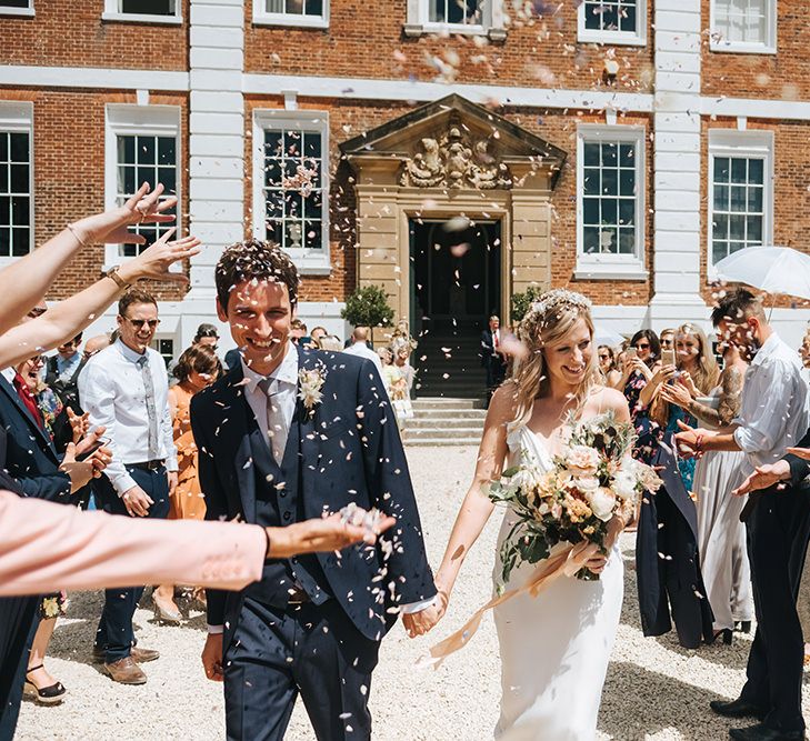 Bride and Groom Smiling During Their Wedding Confetti Moment