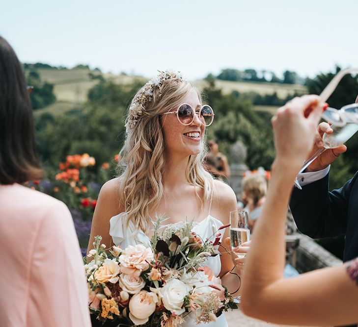 Boho Bride with Flower Crown and Sunglasses enjoying Talking to Her Wedding Guests