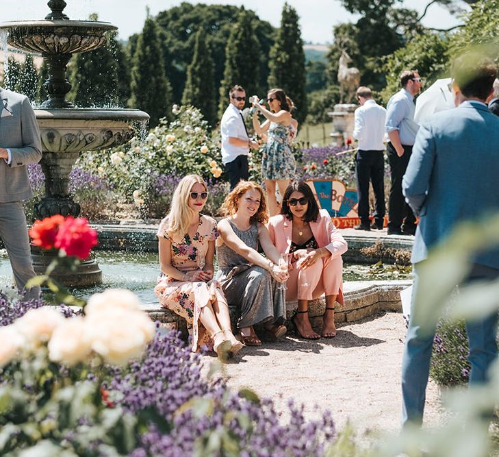 Wedding Guests Sitting in the Gardens of Pynes House, Devon