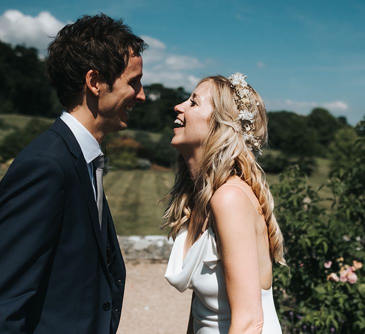 Bride and Groom Laughing Together with Bride in a Cowl Front Wedding Dress