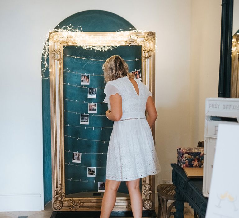 Bridesmaids Pinning Up Her Polaroid Picture on the Giant Frame Guest Book