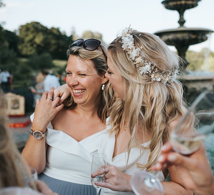 Bride in Flower Crown Hugging Her Wedding Guest