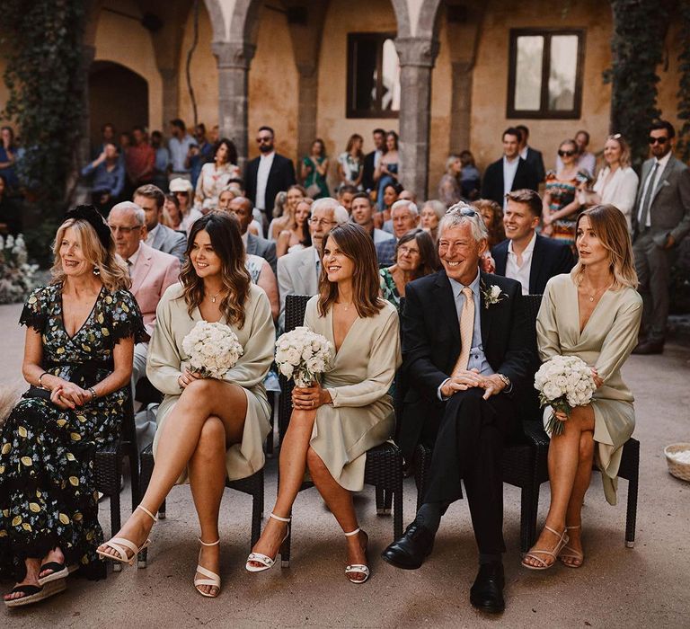 Bridesmaid in beige wrap dresses at wedding ceremony