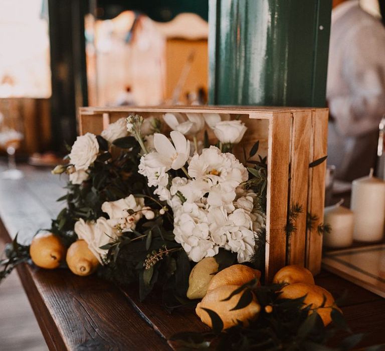 Crate filled with white flowers and lemons