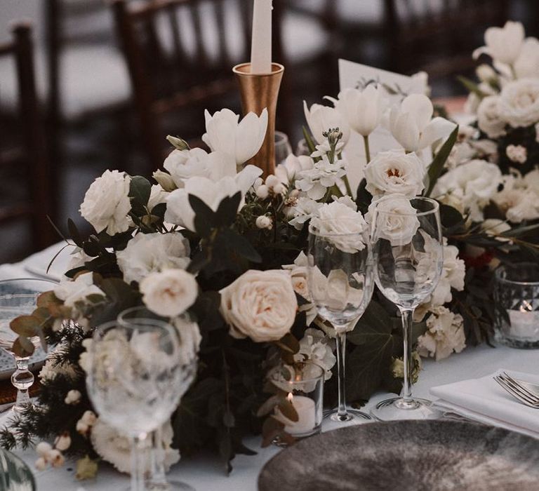 All white wedding flower centrepiece with candles