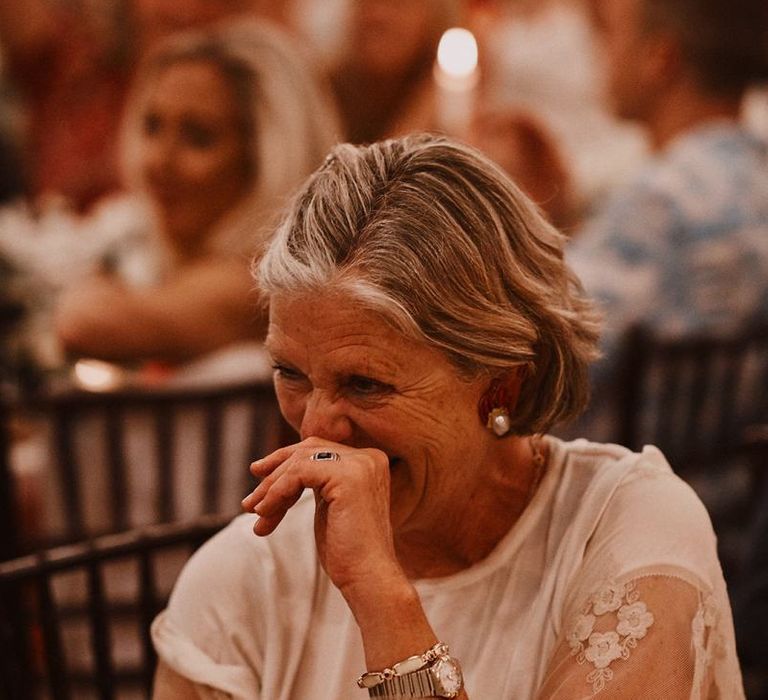 Wedding guest laughing at reception