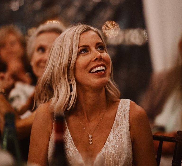 Bride with finger waves hair smiling during the wedding speeches