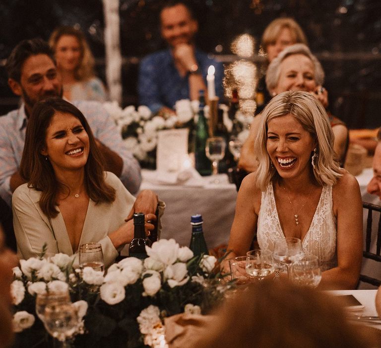 Bride and groom laughing during the wedding speeches