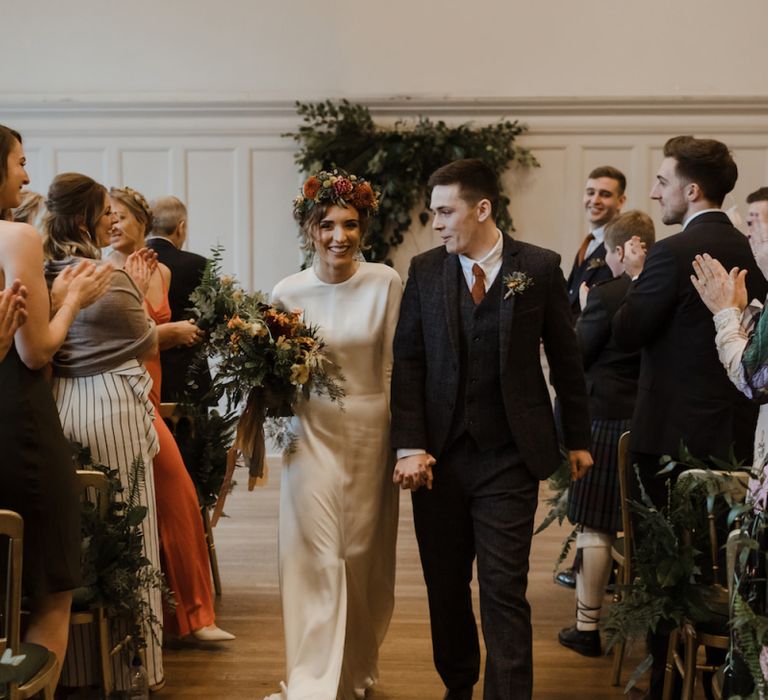 Bride and Groom Just Married Walking Up the Aisle