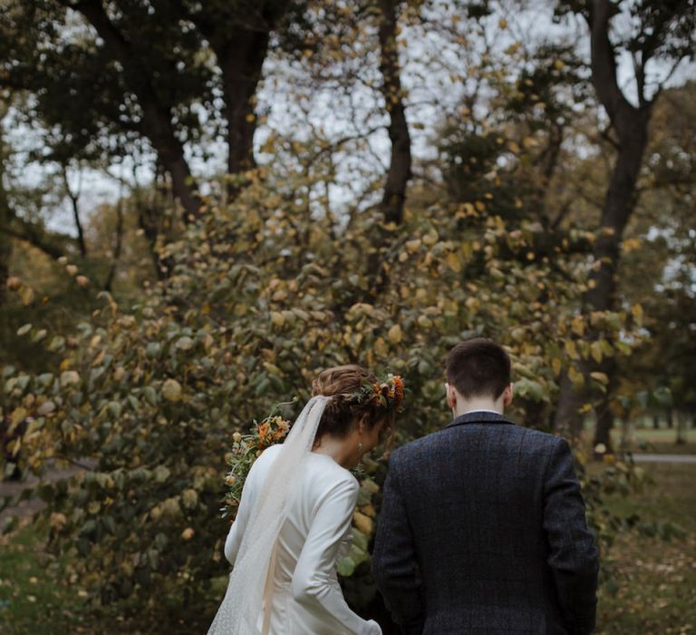 Bride in Satin Wedding Dress and Groom in Wool Suit