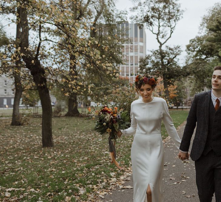 Bride and Groom Autumn Portrait with Leaves on the Ground