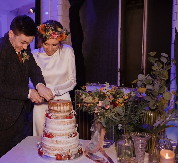 Bride and Groom Cutting The Wedding Cake