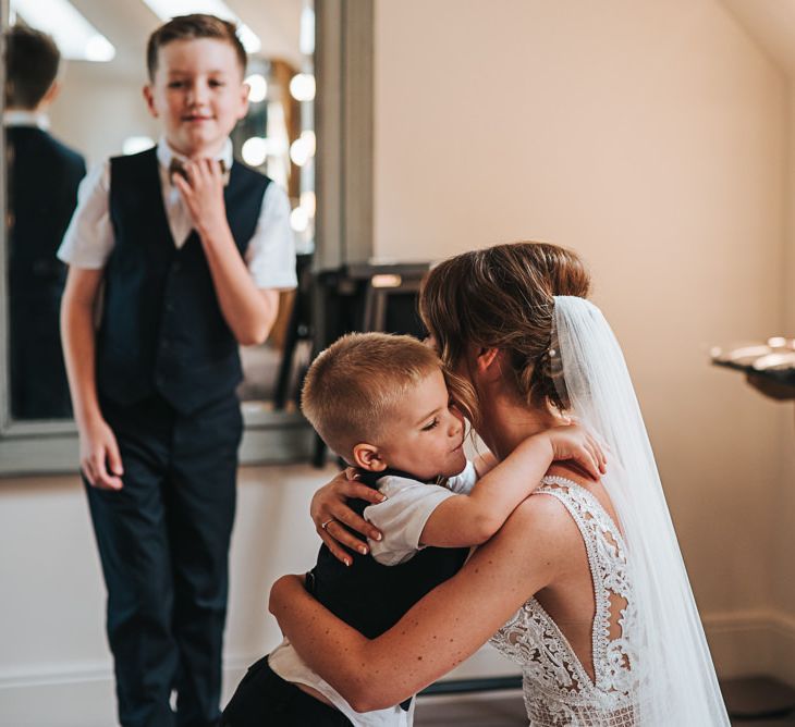 Bride Hugs Son In Pronovias Dress