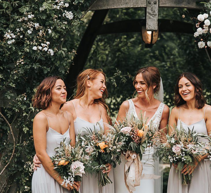 Bridesmaids In Feather Grey Dresses with Bouquets