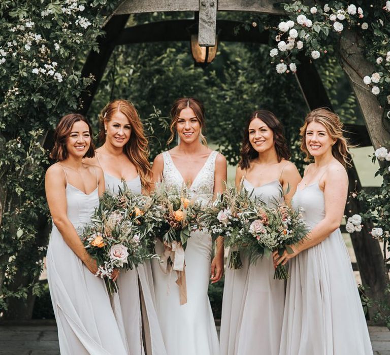 Bridal Party With Bouquets In Grey Dresses