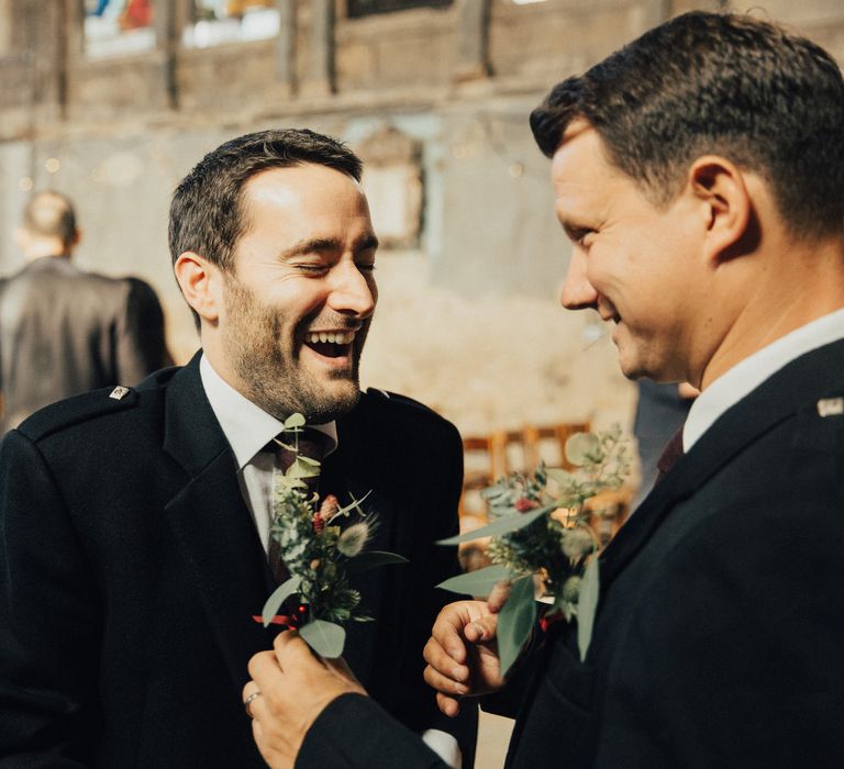 Groom Laughing Putting On his Buttonhole