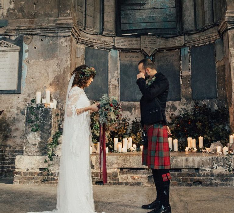 Emotional Groom in Red Tartan Kilt Wiping His Tears as His Bride in a Boho Rue De Seine Wedding Dress Reads Her Wedding Vows