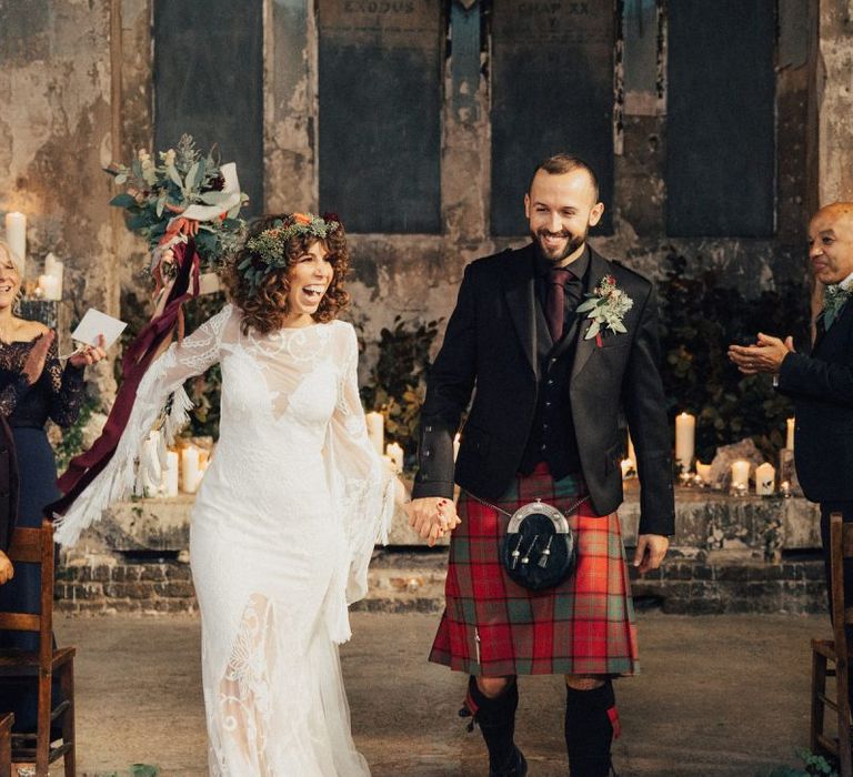 Happy Bride in a Boho Rue De Seine Wedding Dress and Groom in Red Tartan Kilt Just Married