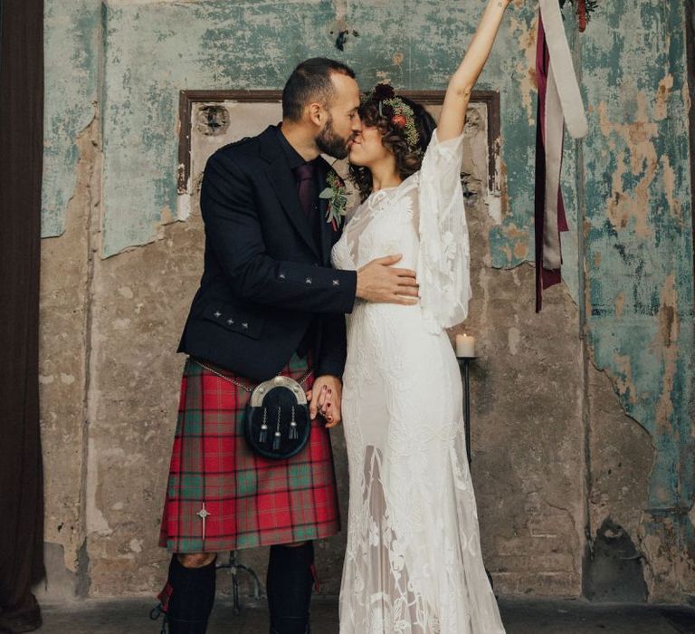 Boho Bride in Lace Rue De Seine Wedding Dress and Groom in Highland Wear Kissing in The Asylum, London