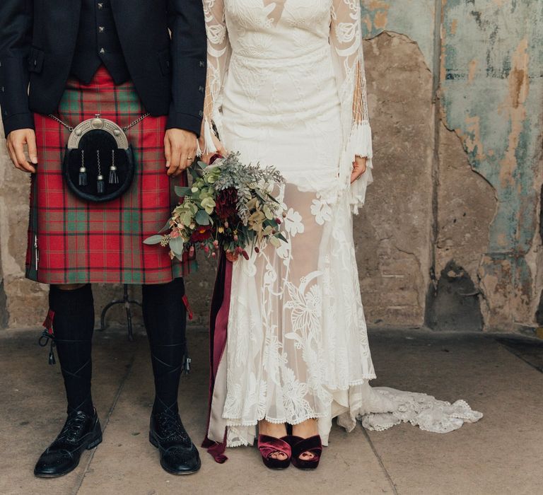 Bride and Groom in Lace Rue De Seine Wedding Dress  and Red Tartan Highland Wear