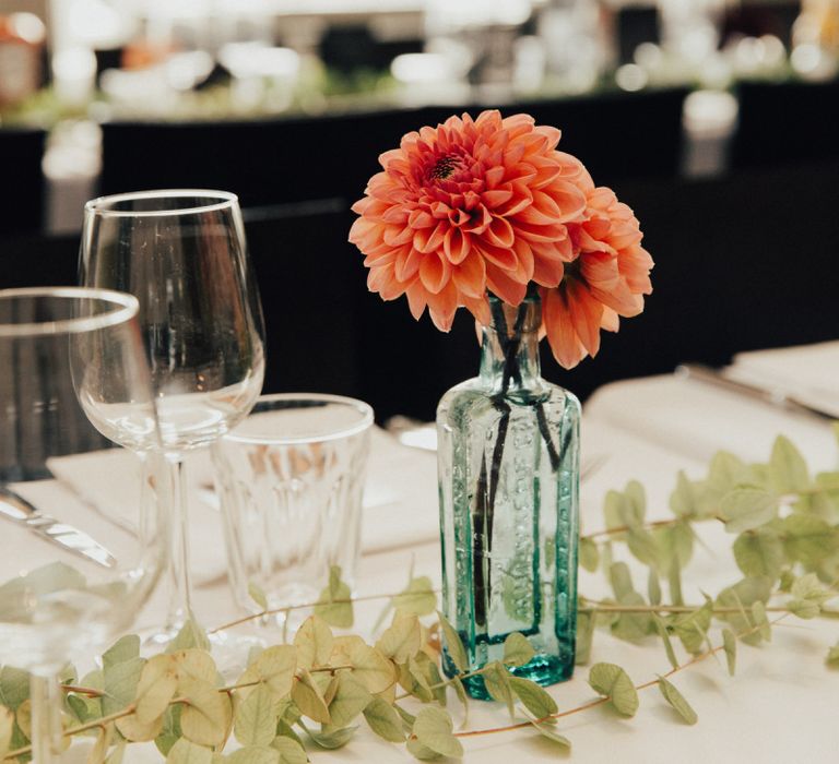 Wedding Decor with Dahlia Pom Pom Heads in a Glass Bottle