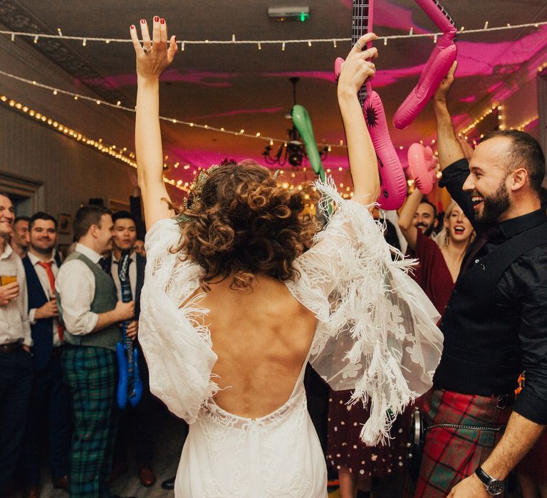 Bride in rue de Seine Wedding Dress and Groom in Highland Wear Sining Karaoke First Dance with Inflatable Props