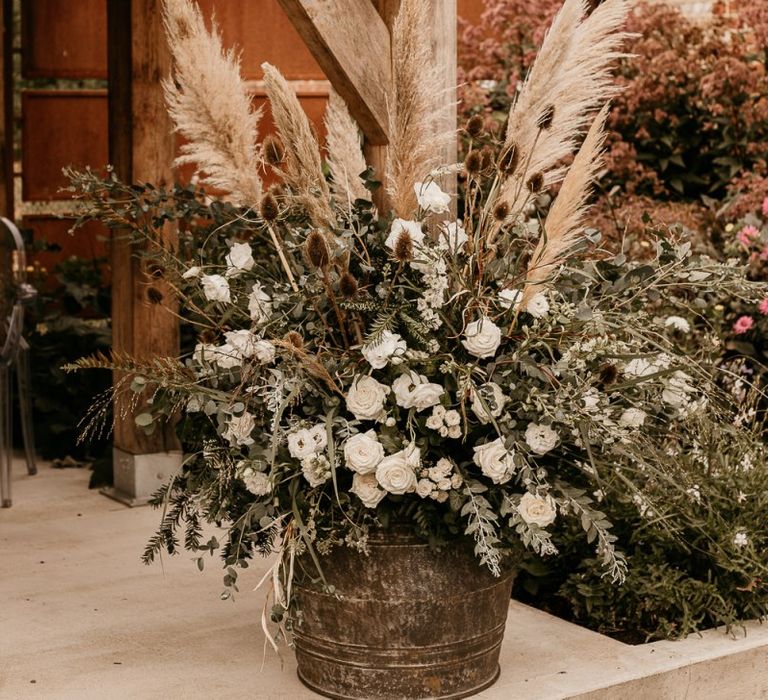 Pampas grass, foliage and white flower floral arrangement