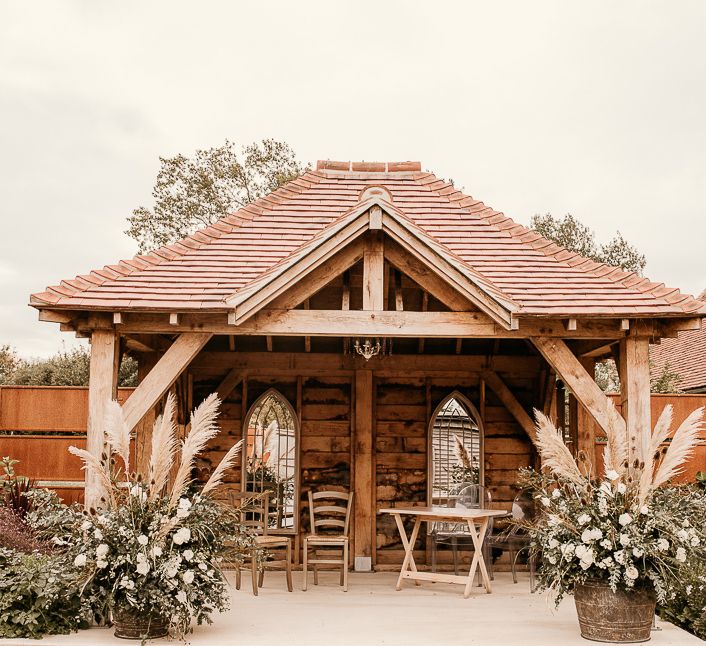 Outdoor pergola at Southend Barns decorated with dried flower arrangement