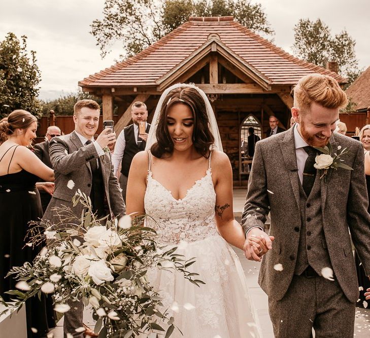 Wedding ceremony confetti exit at Southend Barns with bride in Enzoani wedding dress