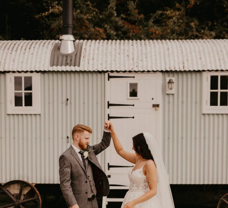 Bride in Enzoani wedding dress and groom in wool suit