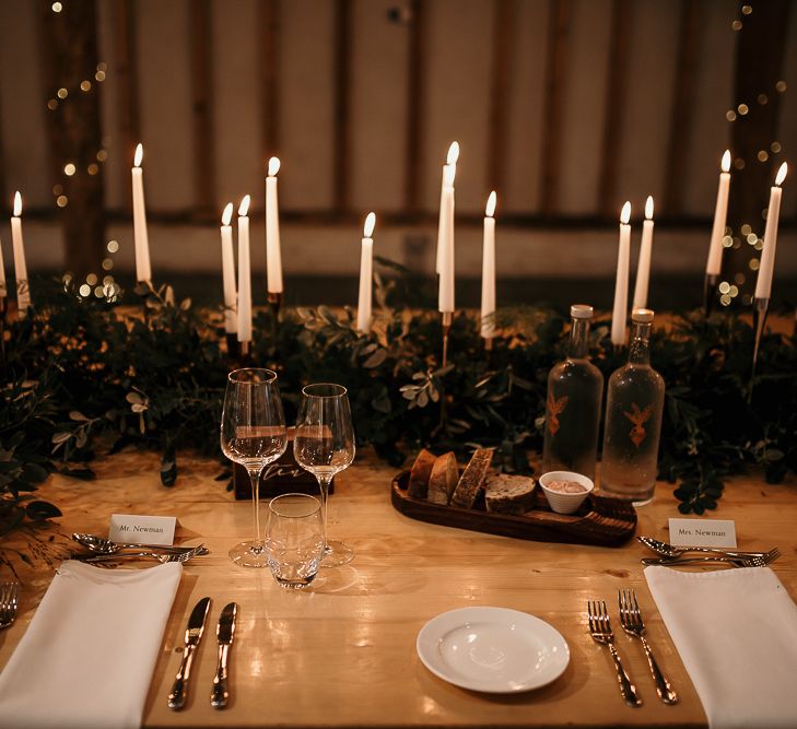 Foliage table runner and taper candles for centrepieces