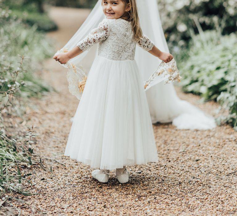 Flower Girl In White Dress // Disney Princess Bride Sleeping Beauty Inspired Wedding With Opulent Florals And Bride In Blush Pink With Images From Rebecca Carpenter Photography