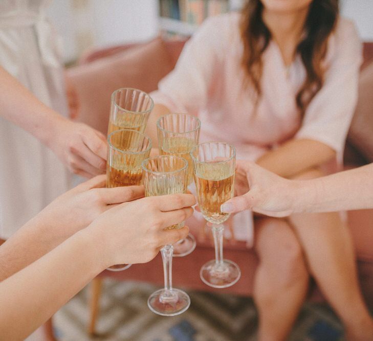 Wedding Morning Bridal Preparations with Bridesmaids Clinking Champagne Glasses